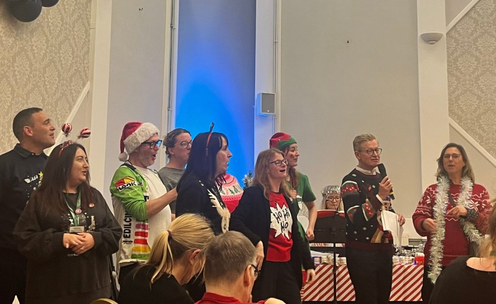 Southdown staff singing Christmas carols at Learning Disability service annual carol concert.||||||||||