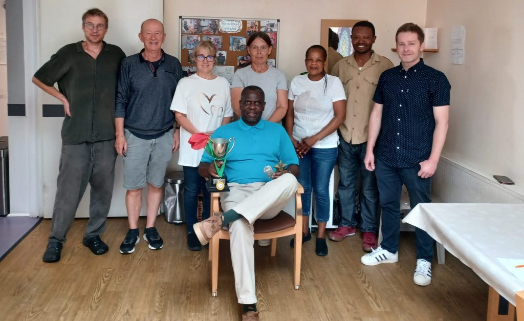 Southdown Mill Lane service team stands as a group with the manager holding the trophy for getting excellent rating.