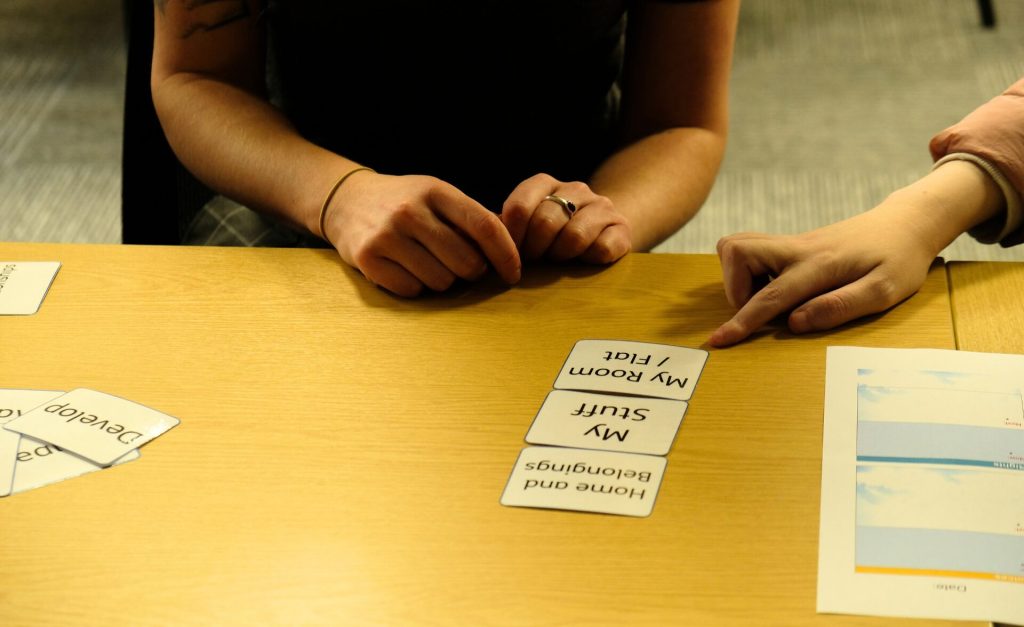 Two people seated at a table during a client involvement session