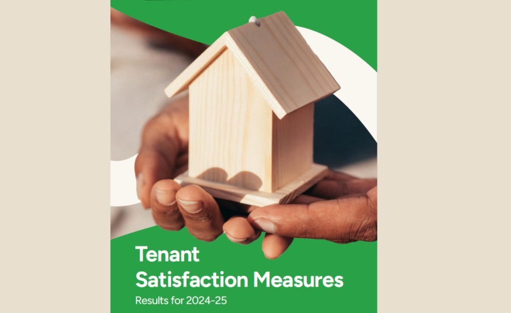 Close-up of hands gently holding a small wooden house model