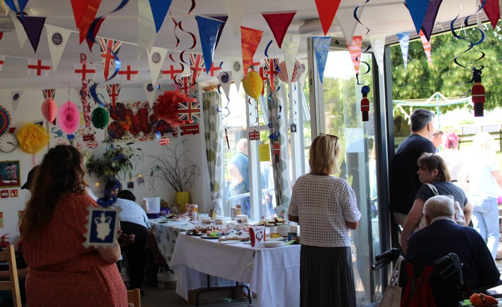 People gathered indoors and outdoors at Bradbury Court’s annual garden party